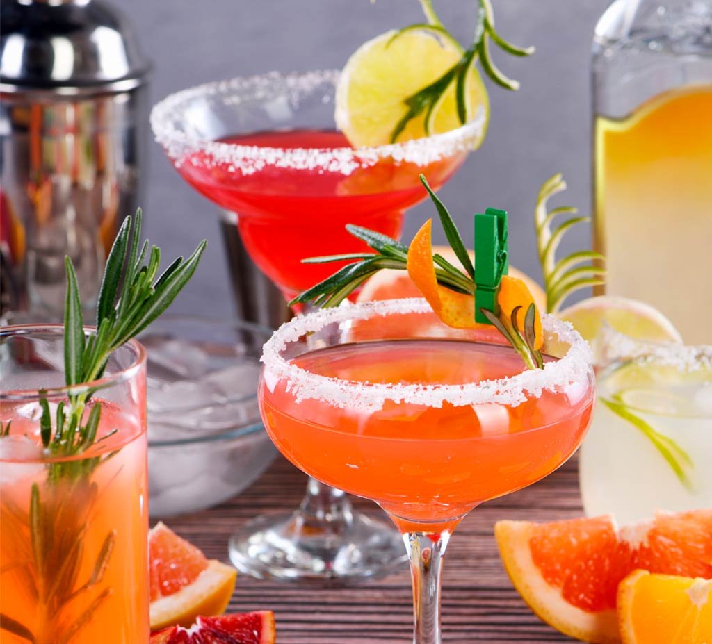 Close-up of a signature drink featuring fresh fruit garnish, served by Cheers On The Wheels mobile cocktail bar.