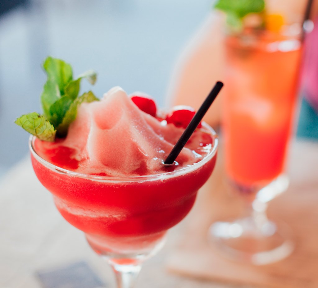Refreshing non-alcoholic frozen mocktail in a branded glass, ideal for wellness events and alcohol-free celebrations.