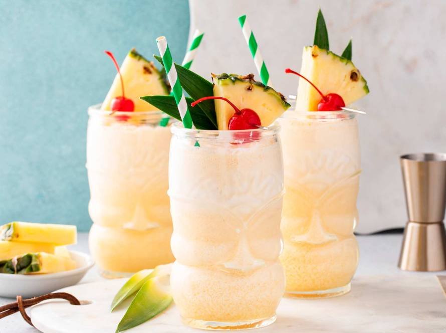 Tropical frozen cocktail served in a stylish glass with fruit garnish, perfect for summer events or beach-themed parties.