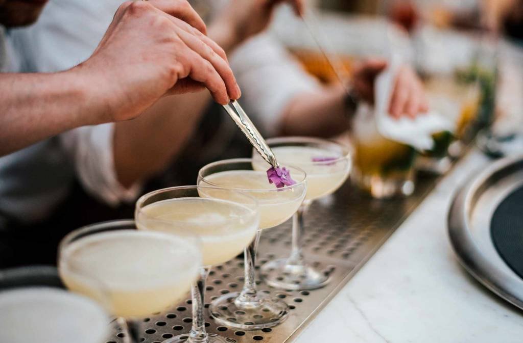 Branded bar menu and themed drink presentation for an immersive event